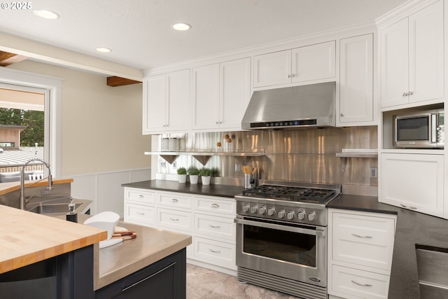3184 SW 73rd Ave, Portland, OR 97225 - kitchen featuring under cabinet range hood, appliances with stainless steel finishes, and white cabinets