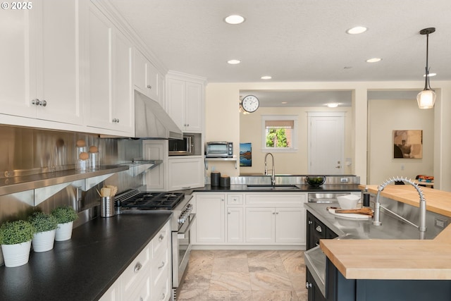 3184 SW 73rd Ave, Portland, OR 97225 - kitchen featuring a sink, recessed lighting, under cabinet range hood, white cabinets, and appliances with stainless steel finishes