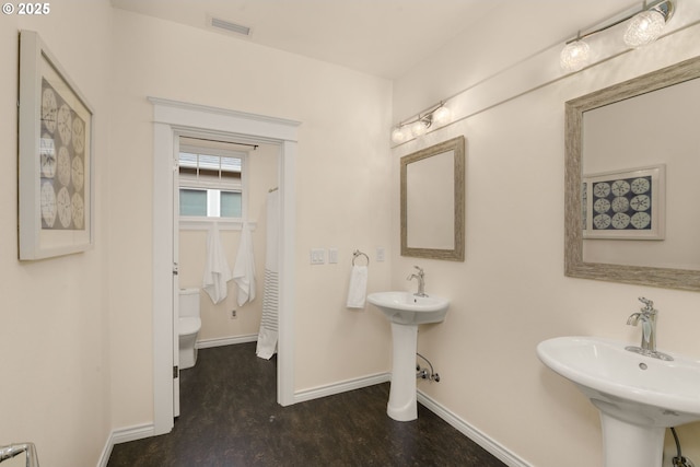 3184 SW 73rd Ave, Portland, OR 97225 - bathroom with a sink, toilet, baseboards, and visible vents