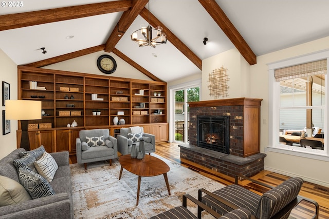 3184 SW 73rd Ave, Portland, OR 97225 - living room featuring wood finished floors, lofted ceiling with beams, a fireplace, and a notable chandelier