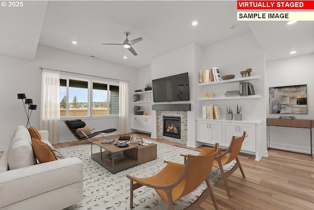 living room with ceiling fan and light wood-type flooring