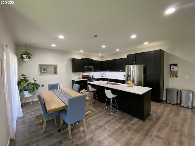 9537 SW 171st Ave, Beaverton, OR 97007 - kitchen featuring stainless steel appliances, dark cabinets, a sink, recessed lighting, and light countertops