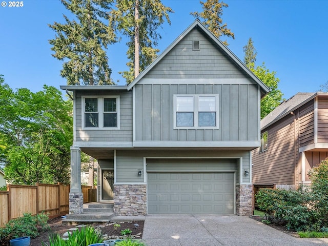 craftsman inspired home with fence, stone siding, board and batten siding, an attached garage, and driveway