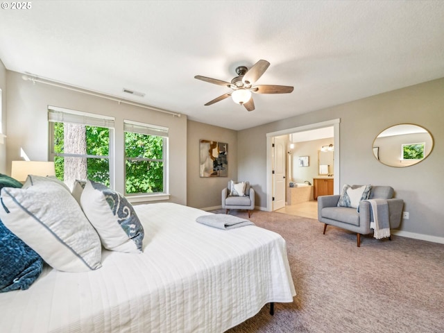 carpeted bedroom featuring baseboards, ceiling fan, connected bathroom, and visible vents