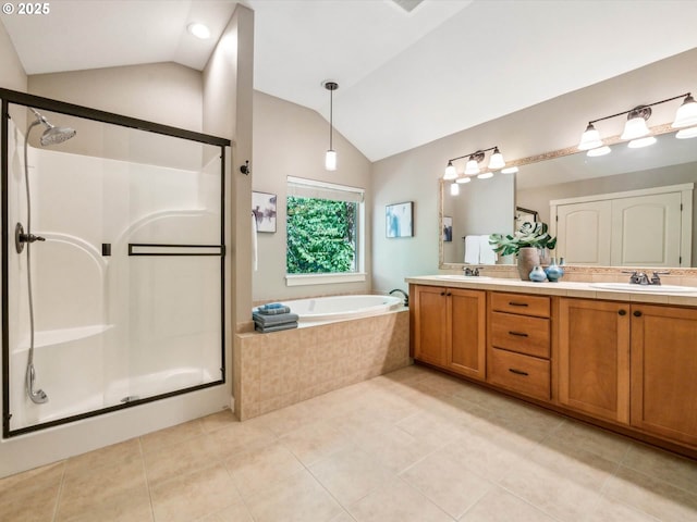 bathroom featuring vaulted ceiling, a sink, tile patterned flooring, and a stall shower