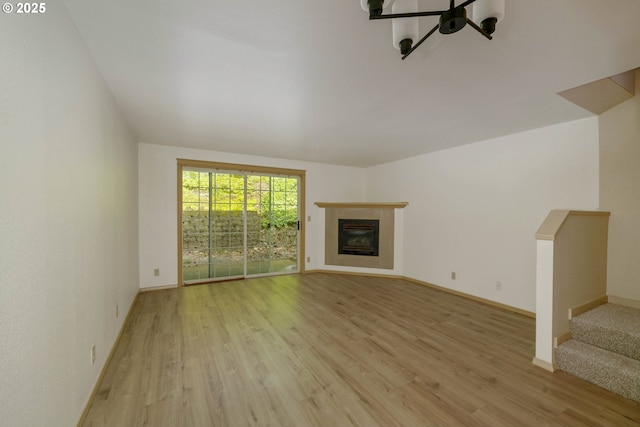 4001 12th St Cut Off SE Unit 18, Salem, OR 97302 - unfurnished living room featuring a glass covered fireplace, light wood-style floors, baseboards, and stairs