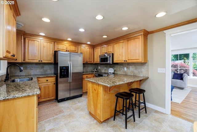 1375 NW Murray Rd, Portland, OR 97229 - kitchen featuring stainless steel appliances, a sink, a peninsula, light stone countertops, and recessed lighting