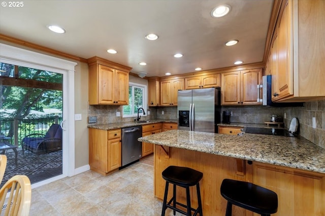 1375 NW Murray Rd, Portland, OR 97229 - kitchen with appliances with stainless steel finishes, a sink, a peninsula, light stone countertops, and backsplash