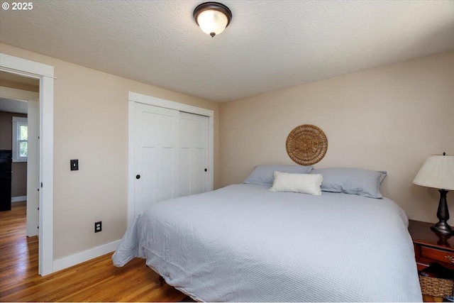 1375 NW Murray Rd, Portland, OR 97229 - bedroom featuring wood finished floors, a closet, and baseboards