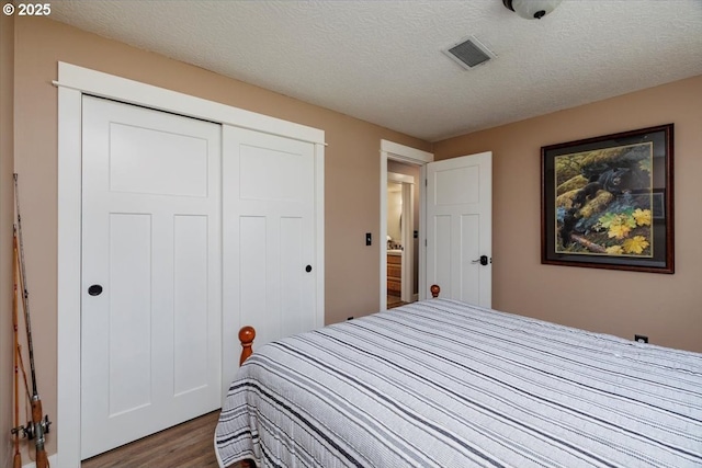 1375 NW Murray Rd, Portland, OR 97229 - bedroom featuring wood finished floors, a closet, and a textured ceiling