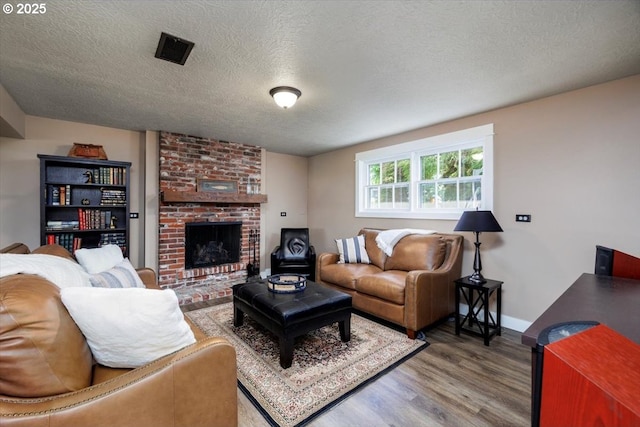 1375 NW Murray Rd, Portland, OR 97229 - living room with wood finished floors, a textured ceiling, a brick fireplace, and baseboards