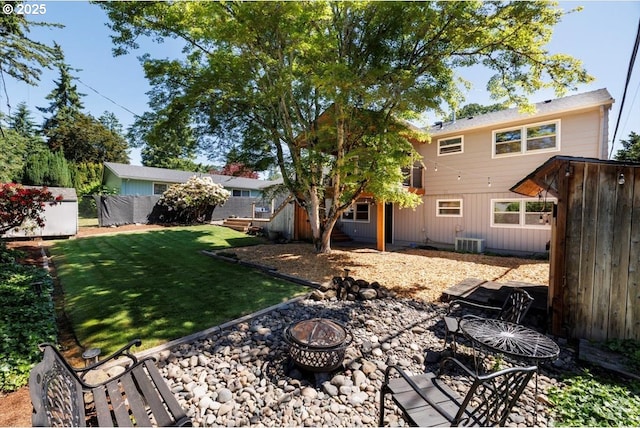 1375 NW Murray Rd, Portland, OR 97229 - back of property with an outdoor fire pit and central AC unit