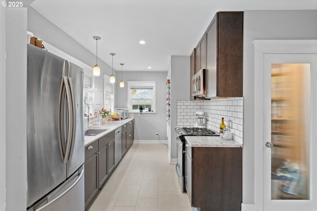 165 15th St, Salem, OR 97301 - kitchen with stainless steel appliances, dark brown cabinets, decorative backsplash, recessed lighting, and light stone counters