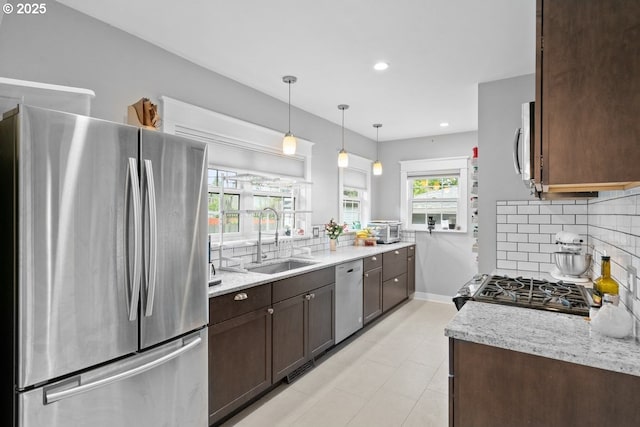 165 15th St, Salem, OR 97301 - kitchen with appliances with stainless steel finishes, dark brown cabinets, tasteful backsplash, light stone counters, and recessed lighting