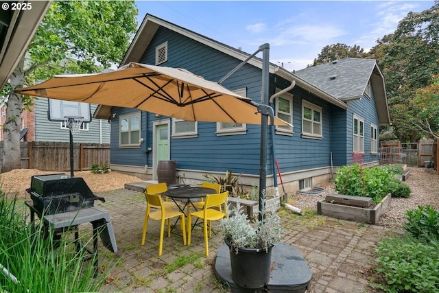 165 15th St, Salem, OR 97301 - back of house with a patio area, roof with shingles, and a vegetable garden