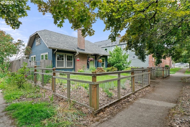 165 15th St, Salem, OR 97301 - view of front facade with a chimney, roof with shingles, and brick siding