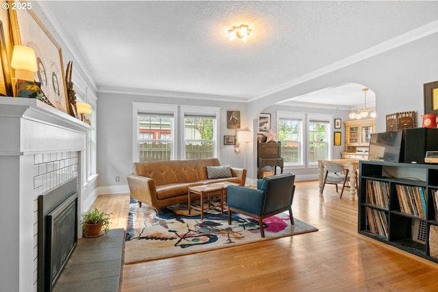 165 15th St, Salem, OR 97301 - living room with arched walkways, plenty of natural light, crown molding, wood finished floors, and a textured ceiling