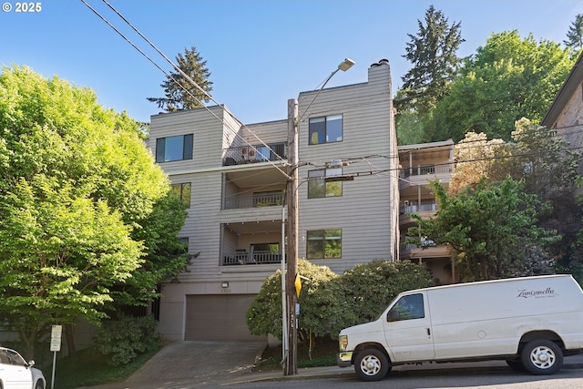 view of building exterior featuring driveway and a garage
