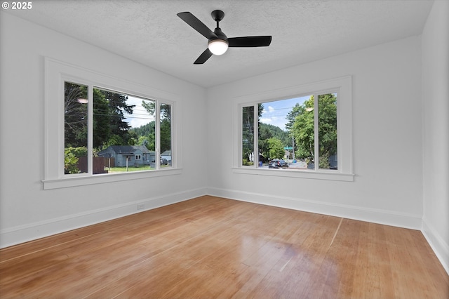 705 SE 5th St, Gresham, OR 97080 - unfurnished room with healthy amount of natural light, light wood-style flooring, a textured ceiling, and a ceiling fan