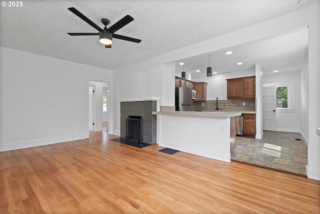 705 SE 5th St, Gresham, OR 97080 - unfurnished living room with light wood-style floors, ceiling fan, a textured ceiling, and recessed lighting