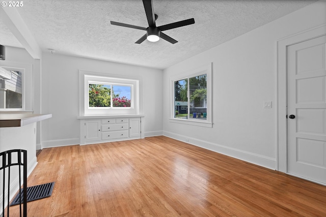 705 SE 5th St, Gresham, OR 97080 - unfurnished living room featuring light wood-type flooring, a ceiling fan, and a textured ceiling