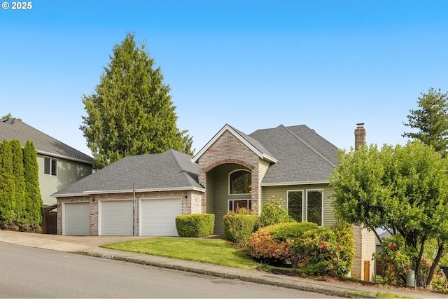4025 Horton Rd, West Linn, OR 97068 - traditional-style house with an attached garage, brick siding, a chimney, driveway, and a shingled roof