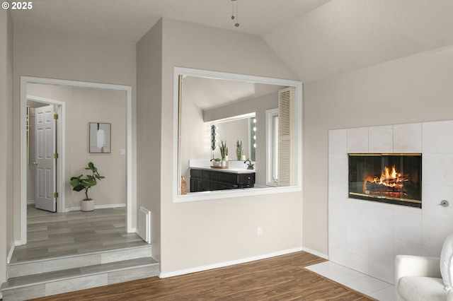 4025 Horton Rd, West Linn, OR 97068 - unfurnished living room featuring wood finished floors, a fireplace, and vaulted ceiling