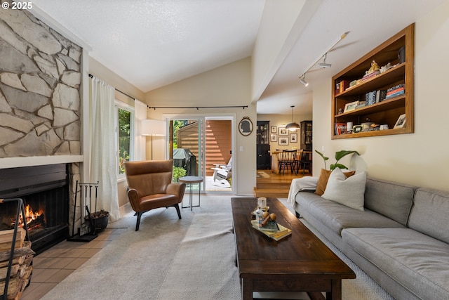4300 Botticelli St, Lake Oswego, OR 97035 - tiled living room featuring a fireplace, lofted ceiling, and track lighting