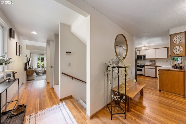 4300 Botticelli St, Lake Oswego, OR 97035 - hall with light wood-style flooring, recessed lighting, and an upstairs landing