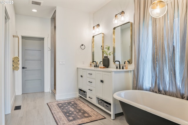 248 Curtis Dr, Longview, WA 98632 - bathroom with a freestanding bath, double vanity, baseboards, and recessed lighting