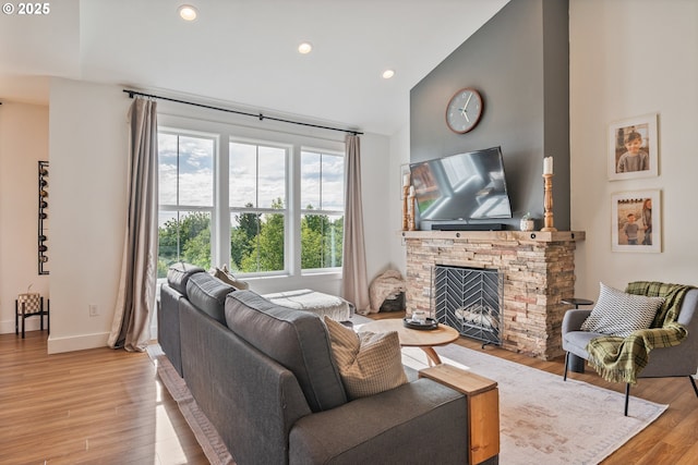 248 Curtis Dr, Longview, WA 98632 - living room featuring high vaulted ceiling, a stone fireplace, light wood-style flooring, recessed lighting, and baseboards