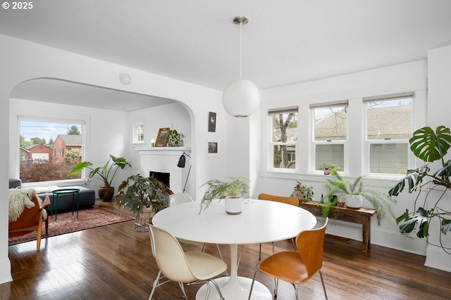 4541 NE 36th Ave, Portland, OR 97211 - dining area featuring a brick fireplace, wood finished floors, and arched walkways