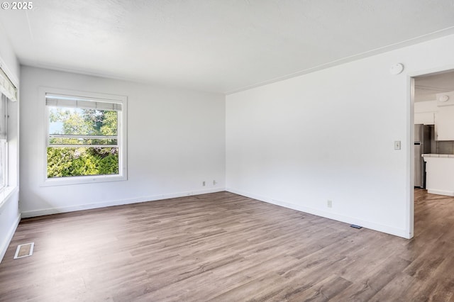 2210 Winter St SE, Salem, OR 97302 - spare room with wood finished floors and a smoke detector