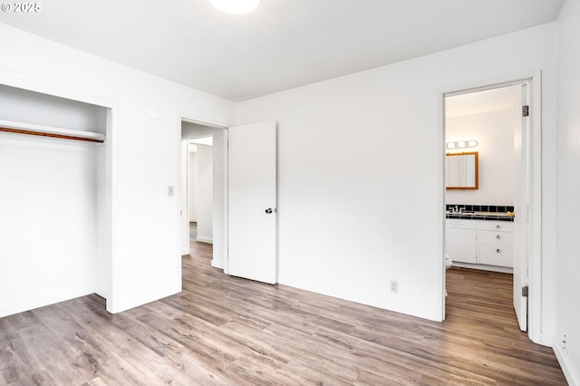 2210 Winter St SE, Salem, OR 97302 - unfurnished bedroom featuring wood finished floors, a closet, and connected bathroom