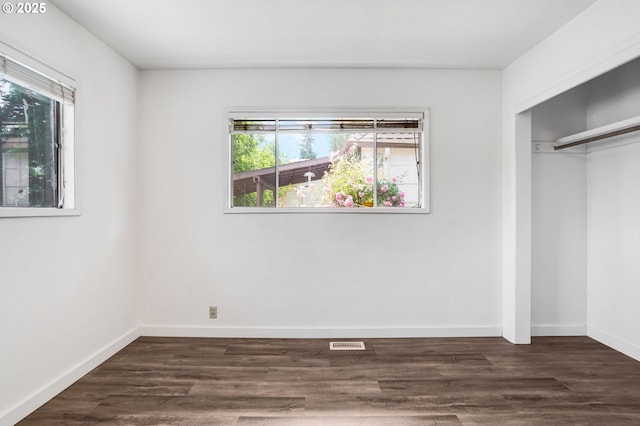 2210 Winter St SE, Salem, OR 97302 - unfurnished bedroom featuring multiple windows, a closet, and dark wood-style floors