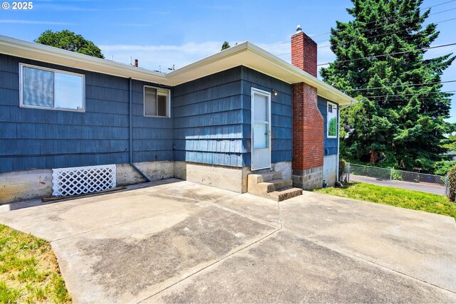2210 Winter St SE, Salem, OR 97302 - view of exterior entry featuring a patio and a chimney