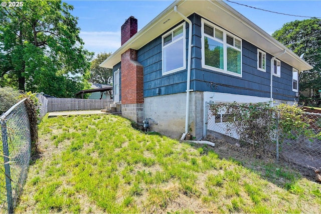 2210 Winter St SE, Salem, OR 97302 - view of side of home with a chimney and a fenced backyard