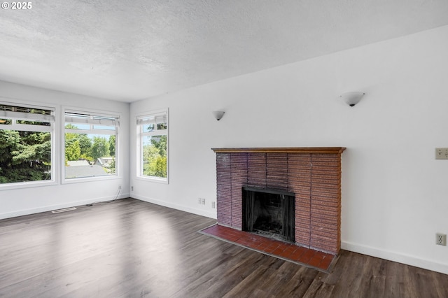 2210 Winter St SE, Salem, OR 97302 - unfurnished living room featuring wood finished floors, a brick fireplace, and a textured ceiling
