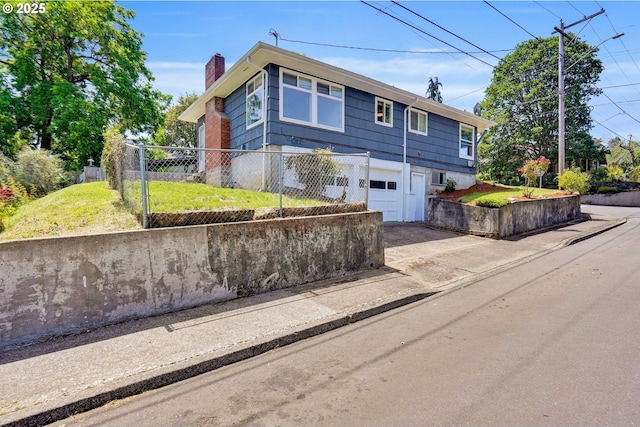 2210 Winter St SE, Salem, OR 97302 - view of front of house featuring a chimney, a garage, and concrete driveway