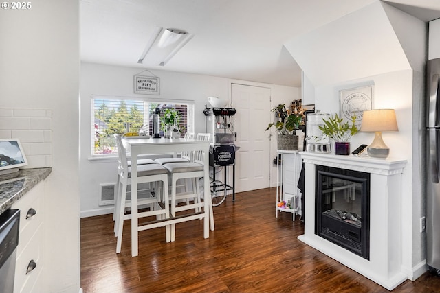 2210 Winter St SE, Salem, OR 97302 - dining room featuring a glass covered fireplace and dark wood-style flooring