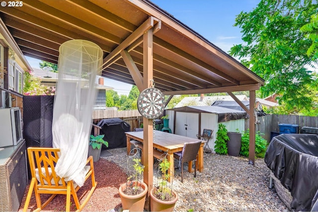 2210 Winter St SE, Salem, OR 97302 - fenced backyard with a storage shed, outdoor dining space, area for grilling, and a patio
