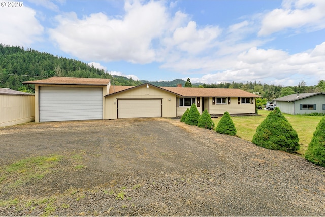 1223 Sable Dr, Roseburg, OR 97470 - view of front of house with a garage, driveway, and a chimney