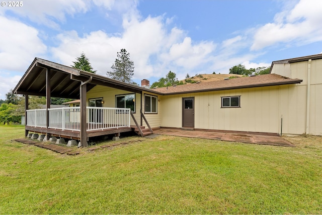 1223 Sable Dr, Roseburg, OR 97470 - rear view of property featuring a lawn, a deck, a chimney, and a patio area