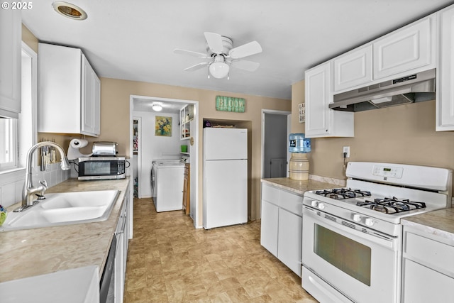 730 23rd St, Springfield, OR 97477 - kitchen featuring stainless steel appliances, under cabinet range hood, washer / clothes dryer, white cabinetry, and light countertops