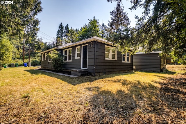 view of side of home featuring a lawn