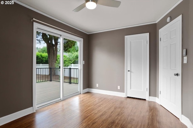 8835 NE Broadway, Portland, OR 97220 - spare room featuring wood finished floors, ornamental molding, a ceiling fan, baseboards, and a smoke detector