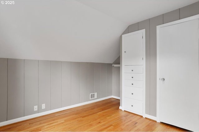 8835 NE Broadway, Portland, OR 97220 - additional living space featuring lofted ceiling, wood finished floors, and baseboards