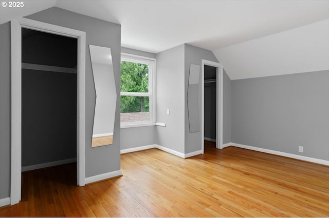 8835 NE Broadway, Portland, OR 97220 - unfurnished bedroom with lofted ceiling, wood finished floors, and baseboards