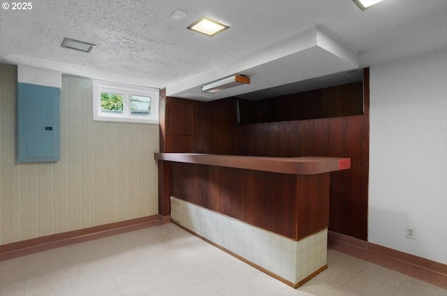 8835 NE Broadway, Portland, OR 97220 - bar area featuring electric panel, a textured ceiling, light floors, baseboards, and wood walls