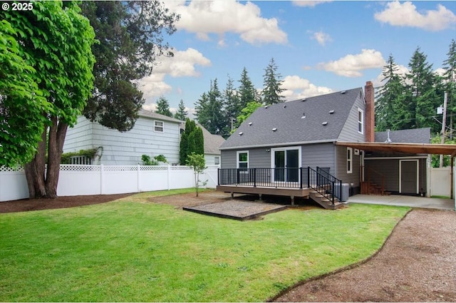 8835 NE Broadway, Portland, OR 97220 - rear view of house featuring a deck, an attached carport, a chimney, and a shingled roof